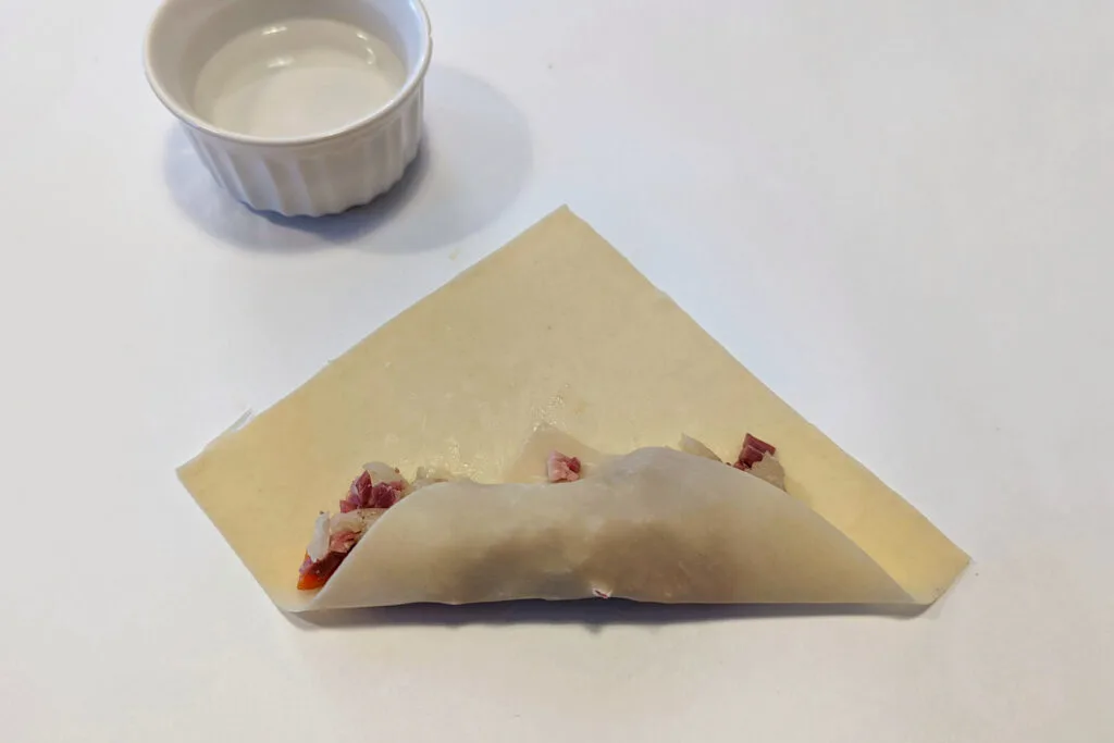 Wrapping an egg roll.