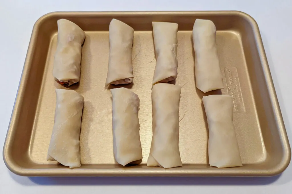 Corned Beef and Cabbage Egg Rolls on a baking sheet.