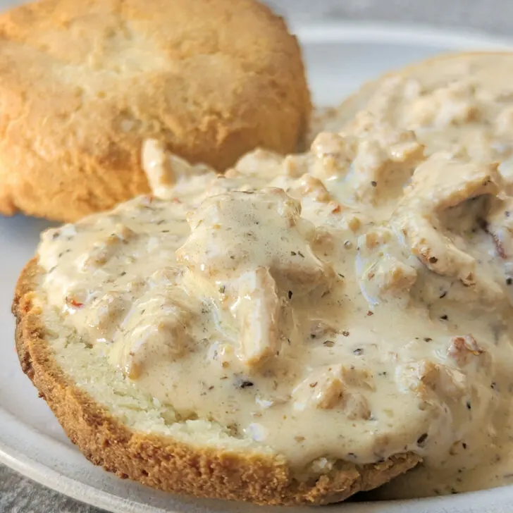 Keto biscuits and gravy in the foreground with biscuits in the background.