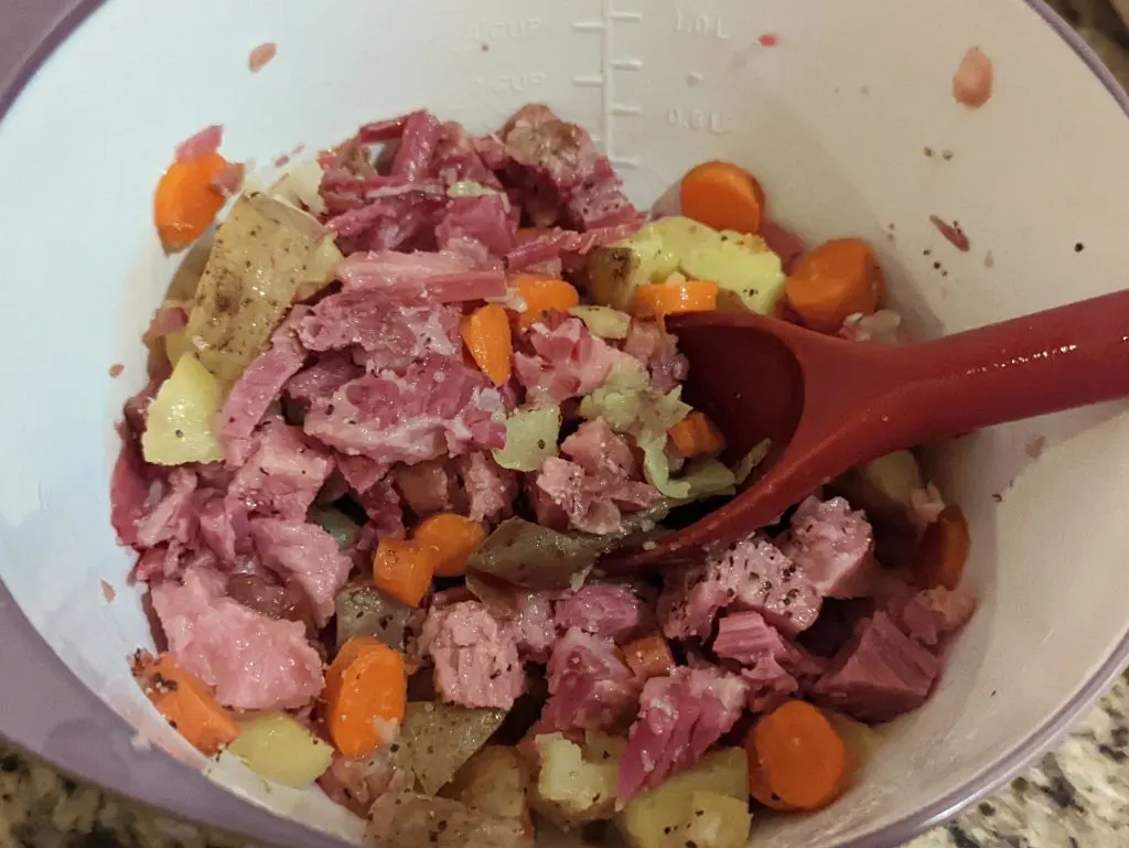 Combine the leftover corned beef and cabbage ingredients in a mixing bowl.