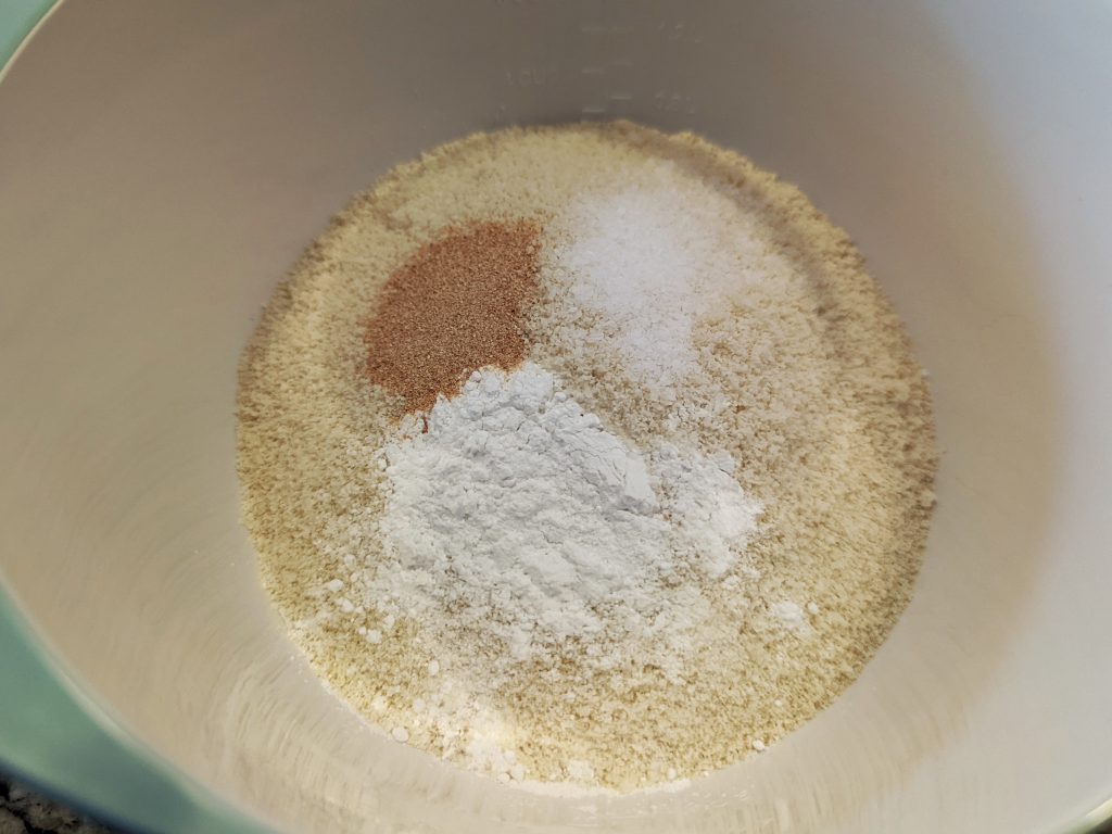 Add almond flour, baking powder, garlic powder, and salt to the eggs.