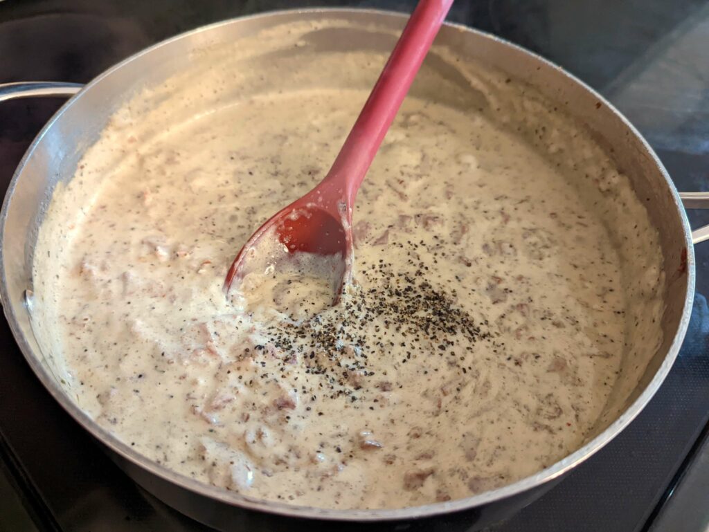 Season the gravy with salt, pepper, and garlic powder.