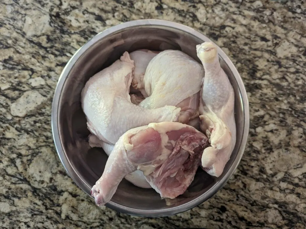 Raw chicken in a mixing bowl.