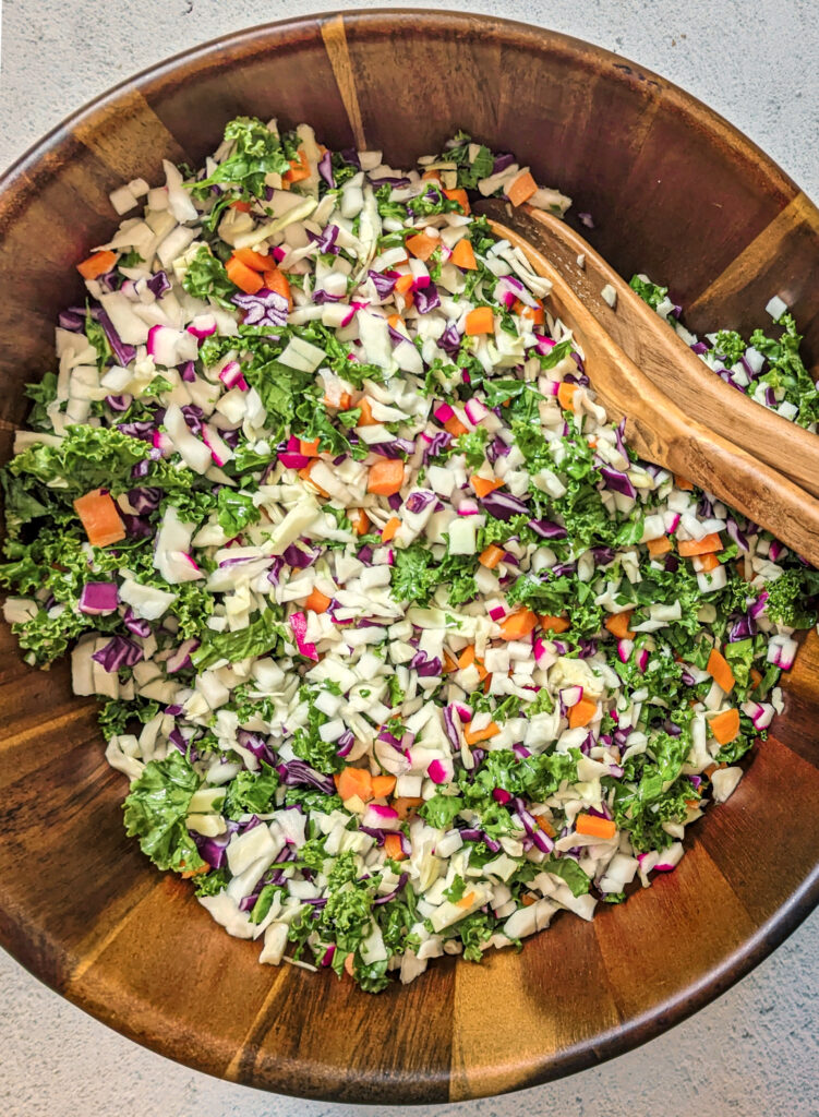 Vegetable chopped salad in a serving bowl with a spoon.