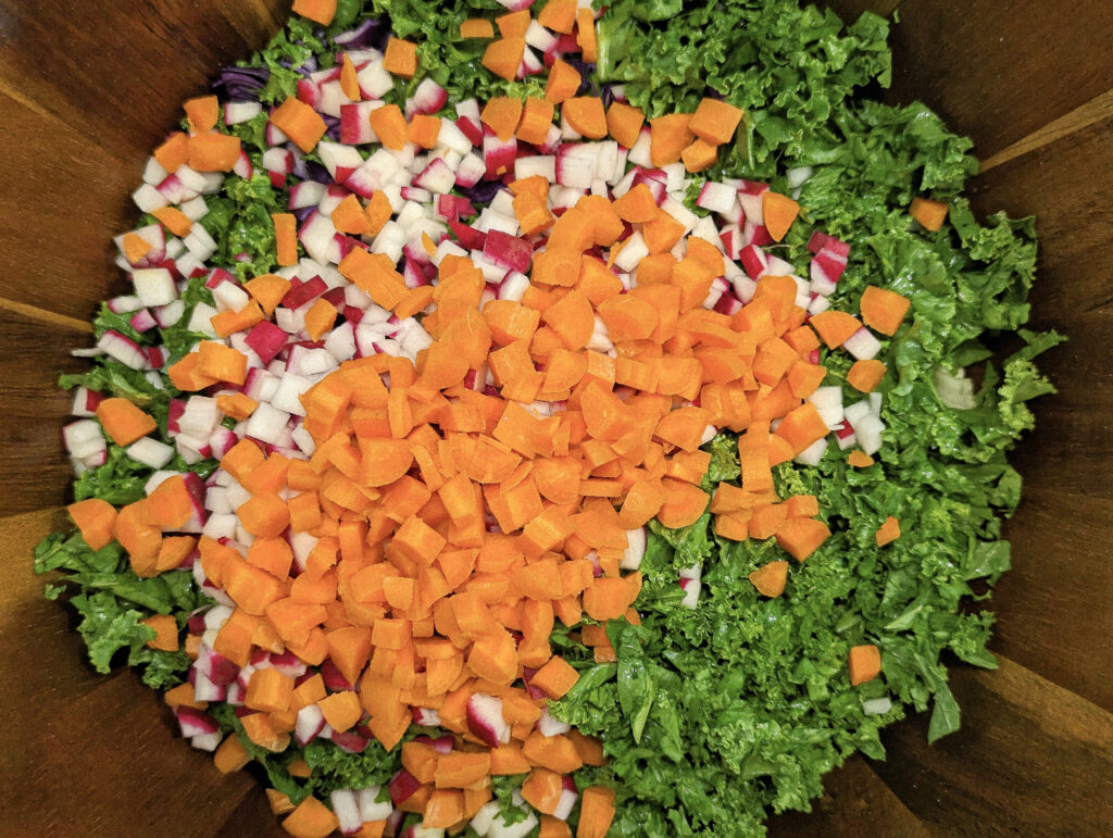 Diced carrots added to a bowl.