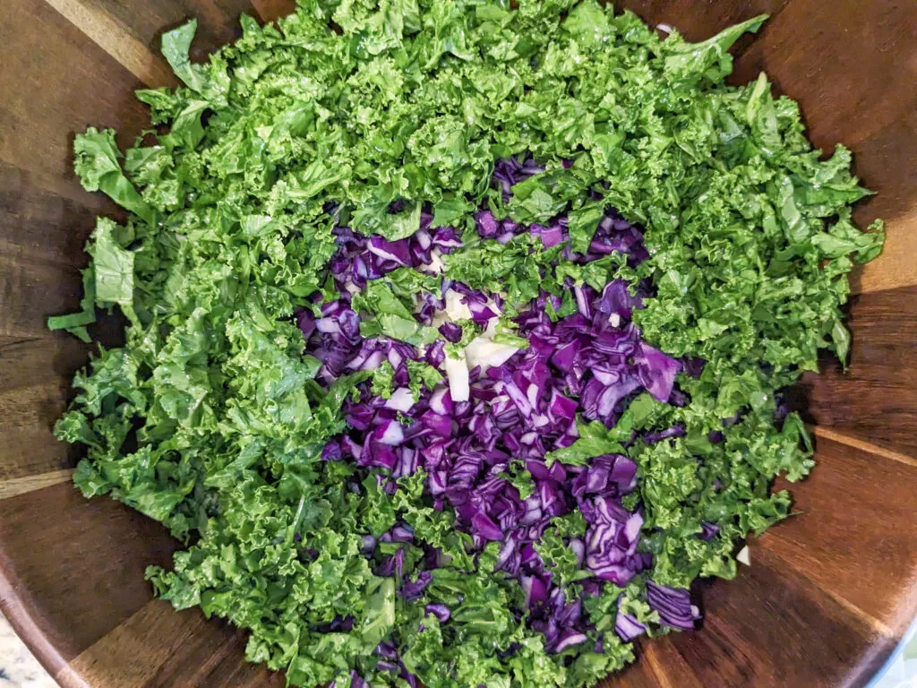 Chopped kale added to a bowl.
