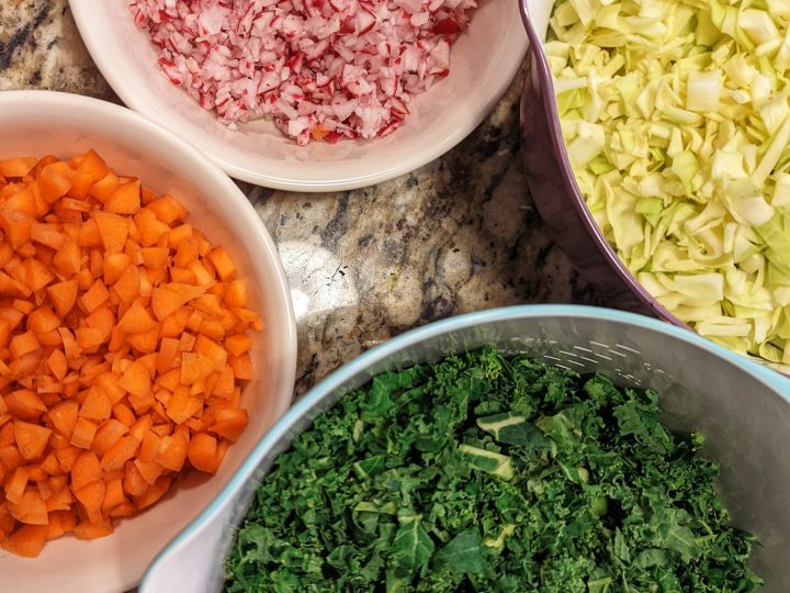 Chop all the ingredients for the chopped salad recipe finely before tossing them together in a mixing bowl.