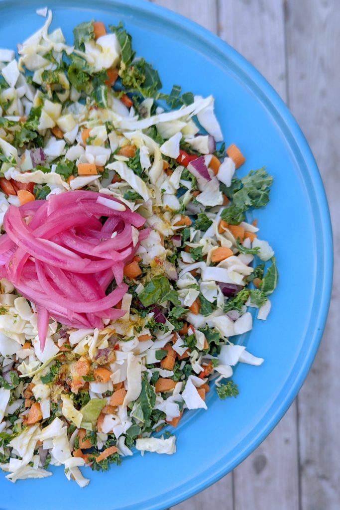 Our chopped salad recipe is garnished with sweet pickled onion.