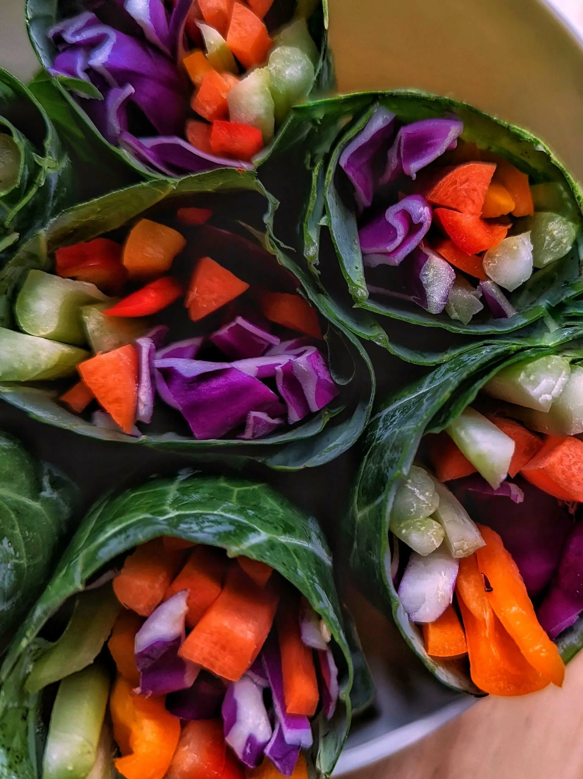 The inside of five rainbow wraps showing the rainbow of vegetables.