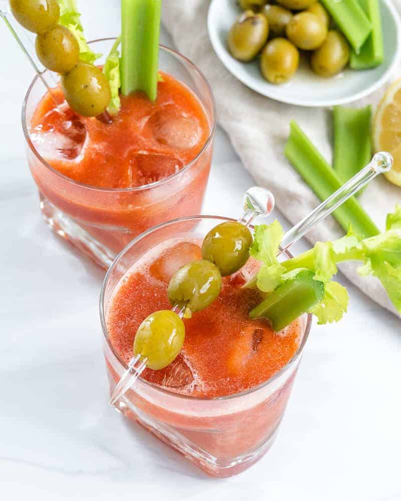 Make a virgin bloody mary mocktail recipes and top it with olives and celery.