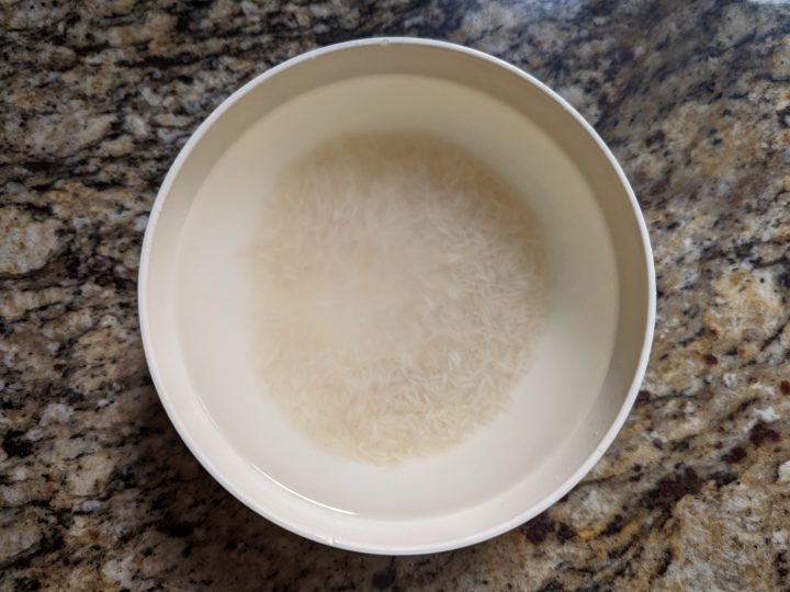 Soak your rice in water and the longer, the better.
