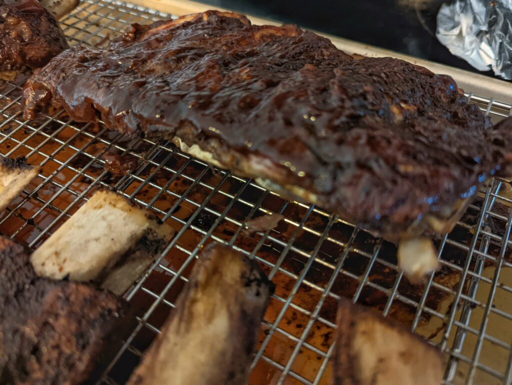 Bbq sauce brushed onto beef ribs.