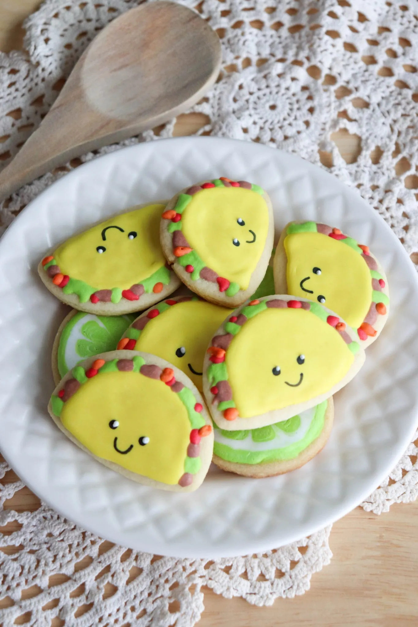 A plate of sugar cookies shaped liked Tacos. 