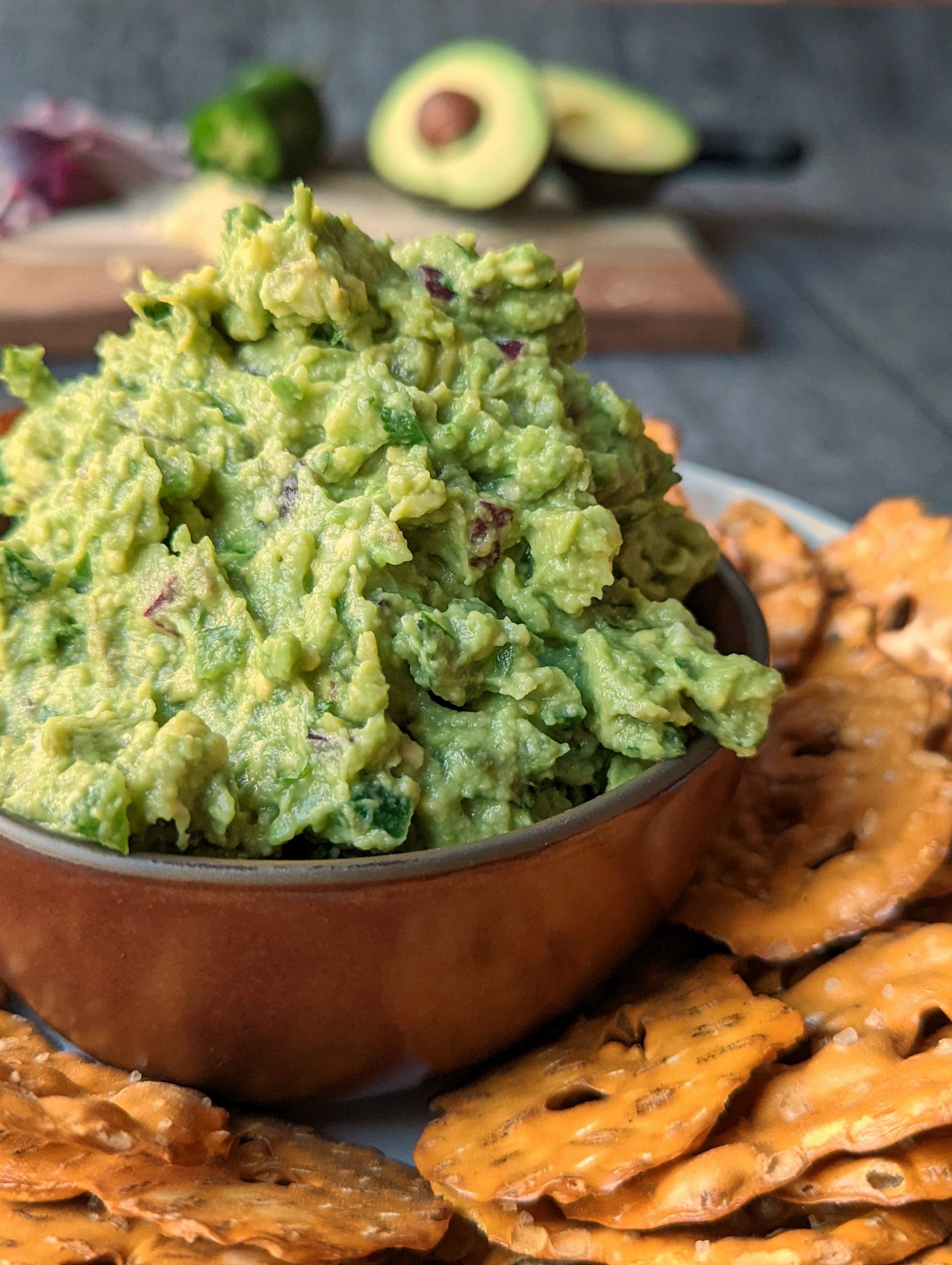 This is our simple guacamole recipe served with pretzel chips.