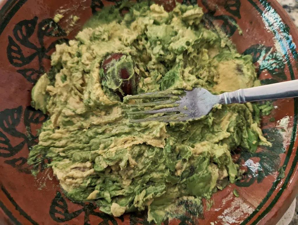 Mash the avocados with a fork.