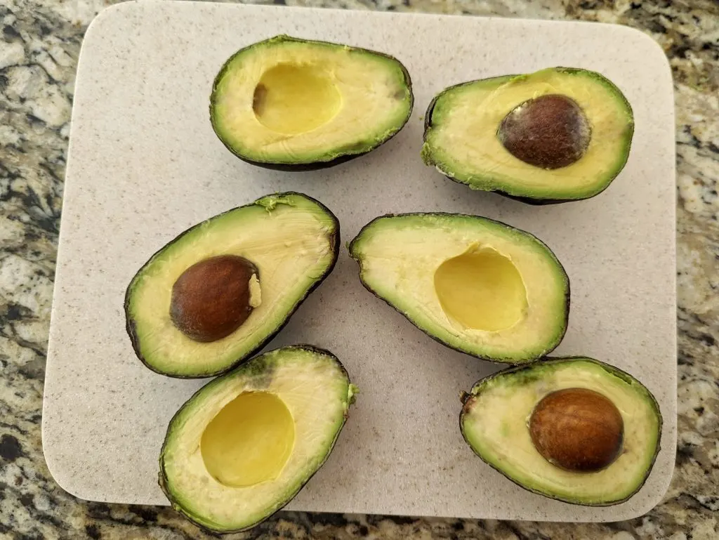 Slice the avocados in half and remove the pit.