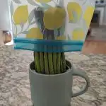 Cover the stems of the asparagus and store them in a cup full of water in the fridge.