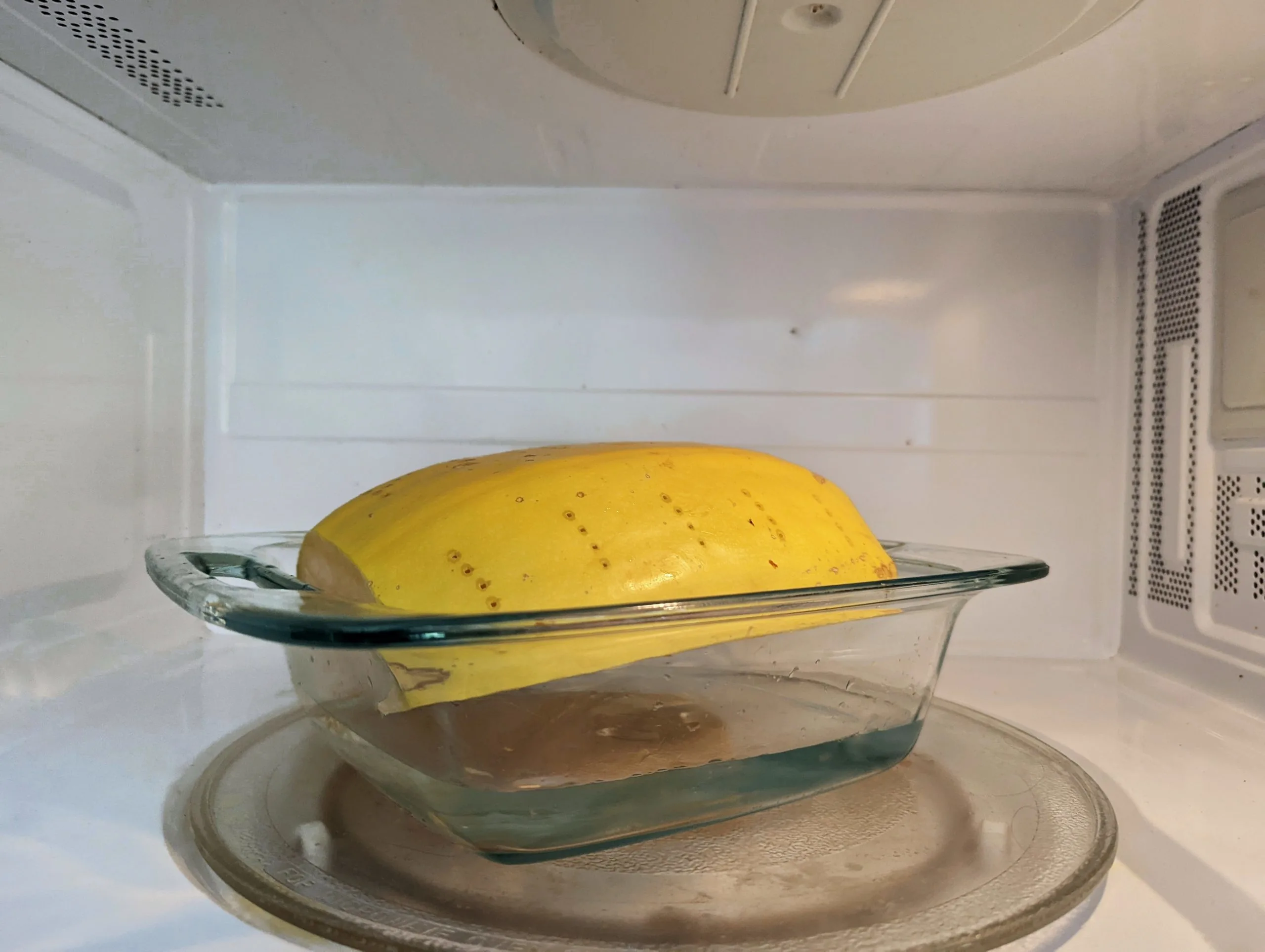 Spaghetti squash cooking in the microwave.