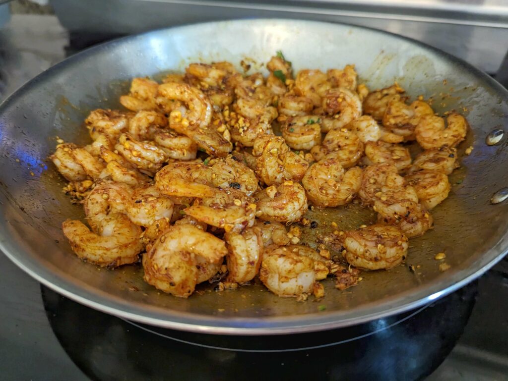 Shrimp added to the cooking peanuts and spices.