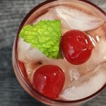A over the top picture of a shirley temple topped with mint.