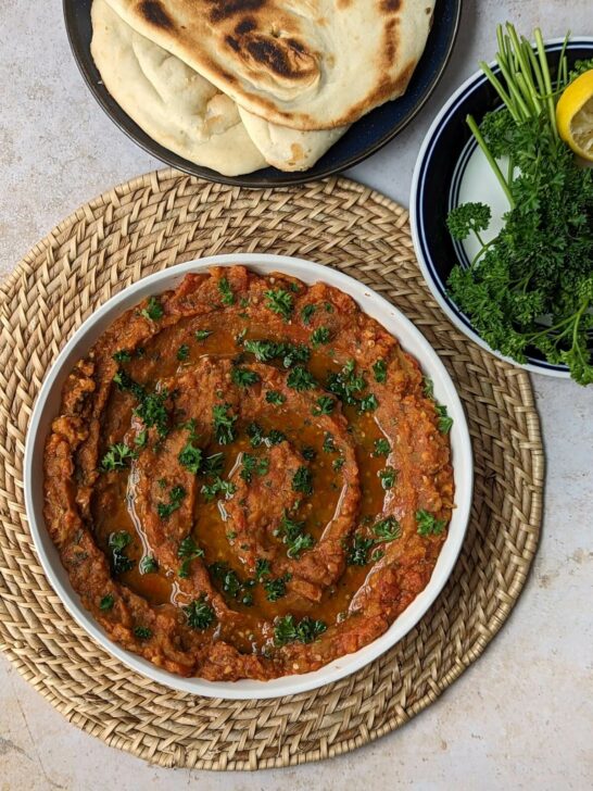 Zaalouk topped with parsley and olive oil and served with fresh bread or pita.