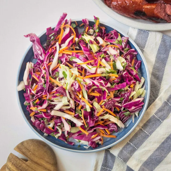 Purple cabbage coleslaw in a serving bowl.