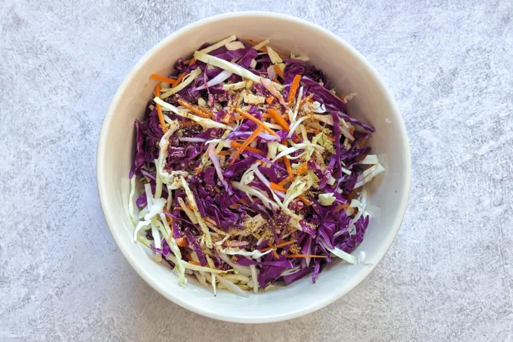 Coleslaw ingredients in a mixing bowl.