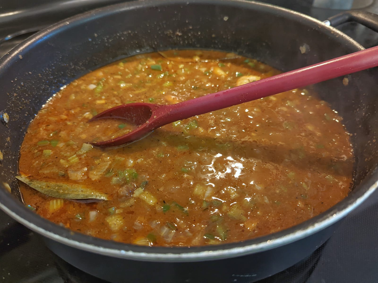 Etouffee sauce simmering in a pan.