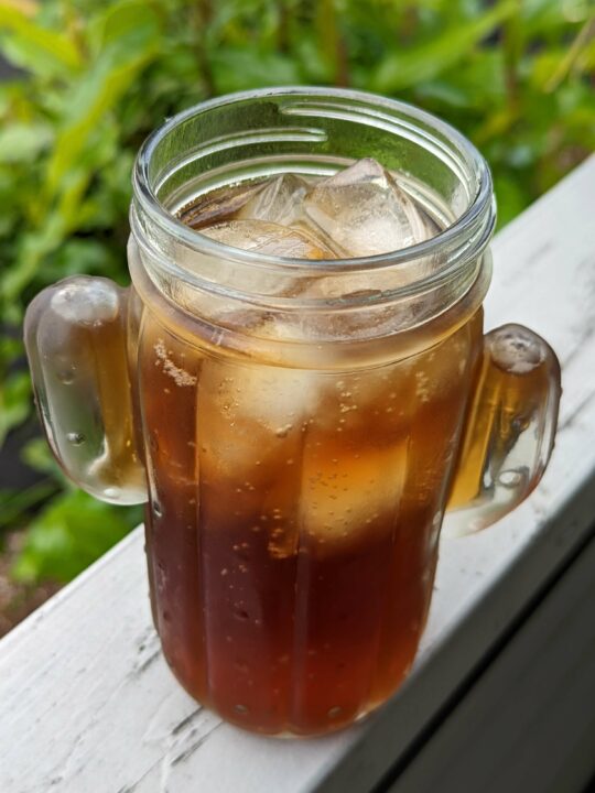 A drinking glass filled with healthy coke.