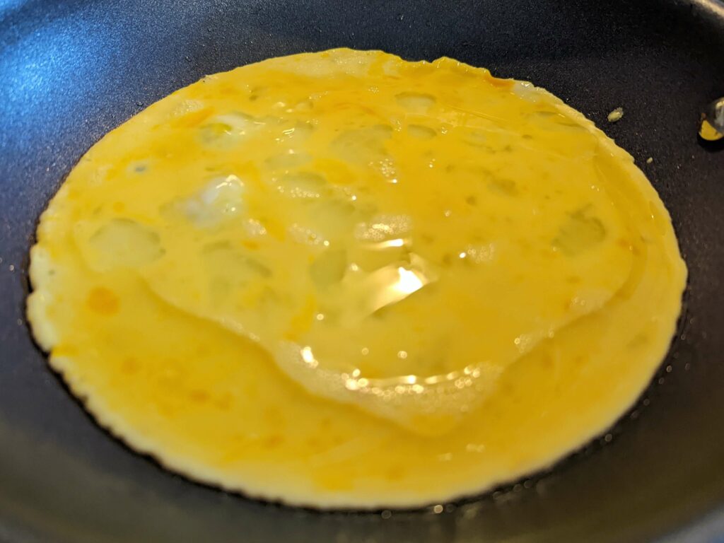Cook the eggs undisturbed for 30 seconds until the edges begin to change.