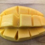 Push out the mango to make a mango flower. This allows for the cubes to be easily cut from the mango.