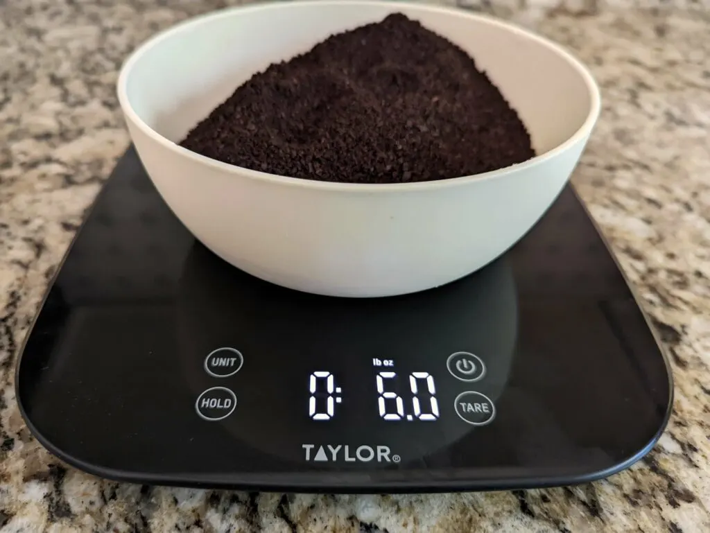 Six ounces of coffee beans on a scale.
