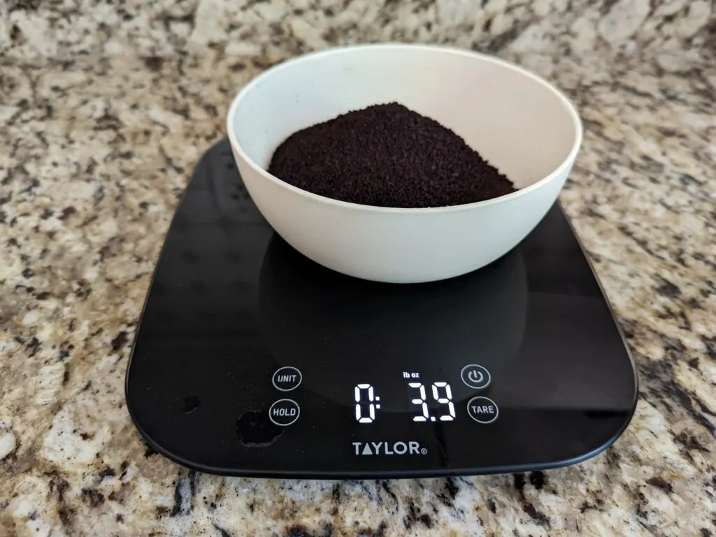 Four ounces of coffee beans on a scale.