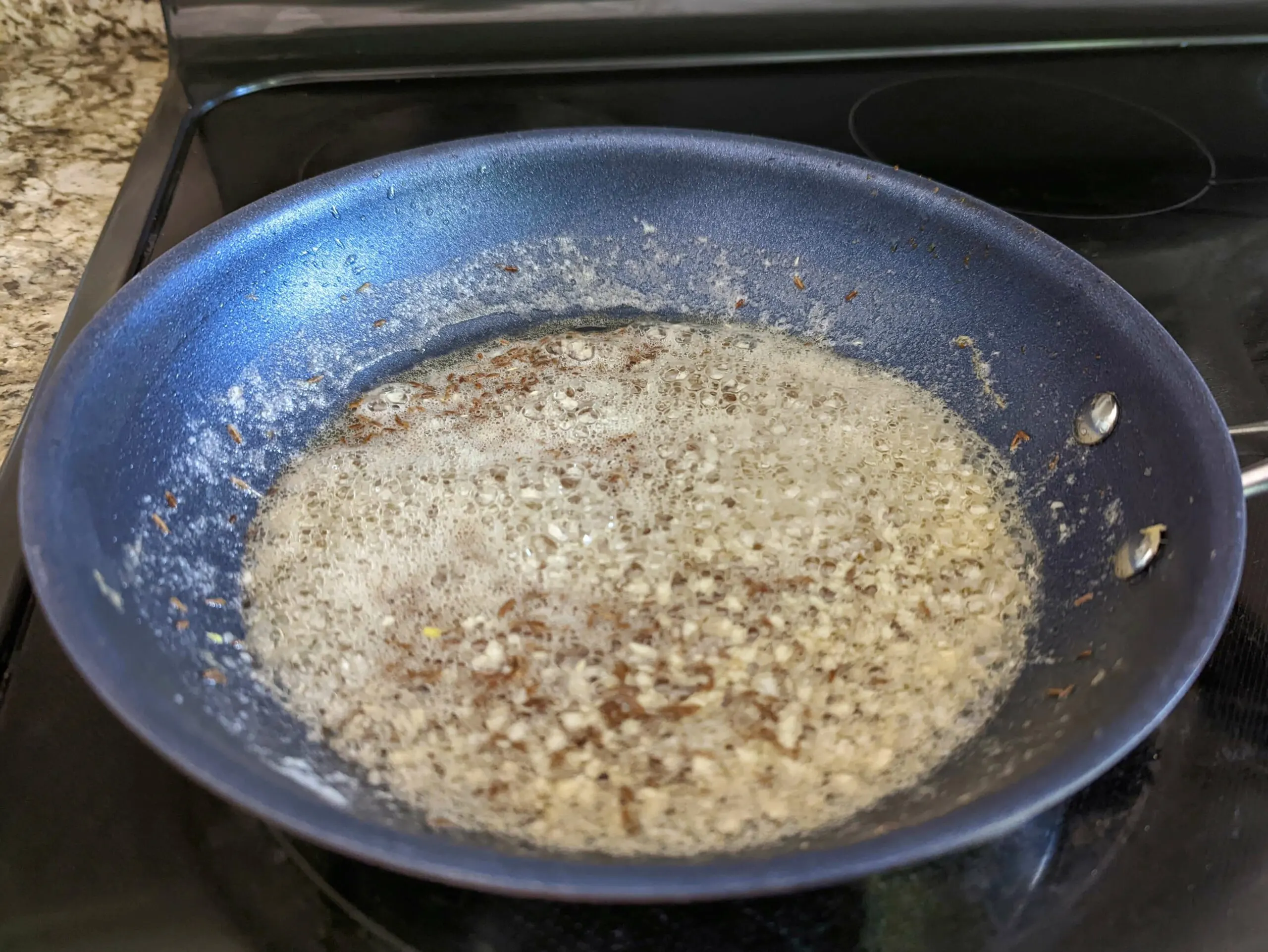 Butter and garlic sautéing in a skillet.