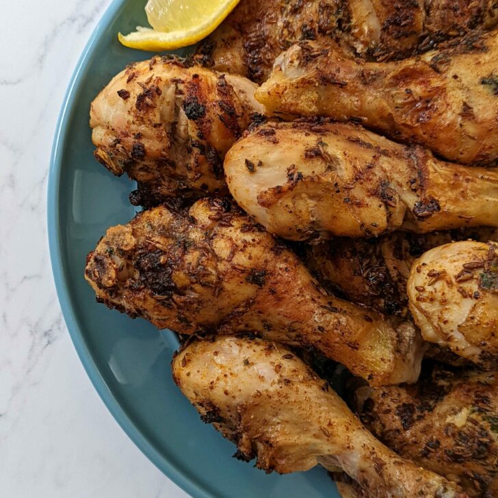 Roasted chicken on a plate and served with lemon.