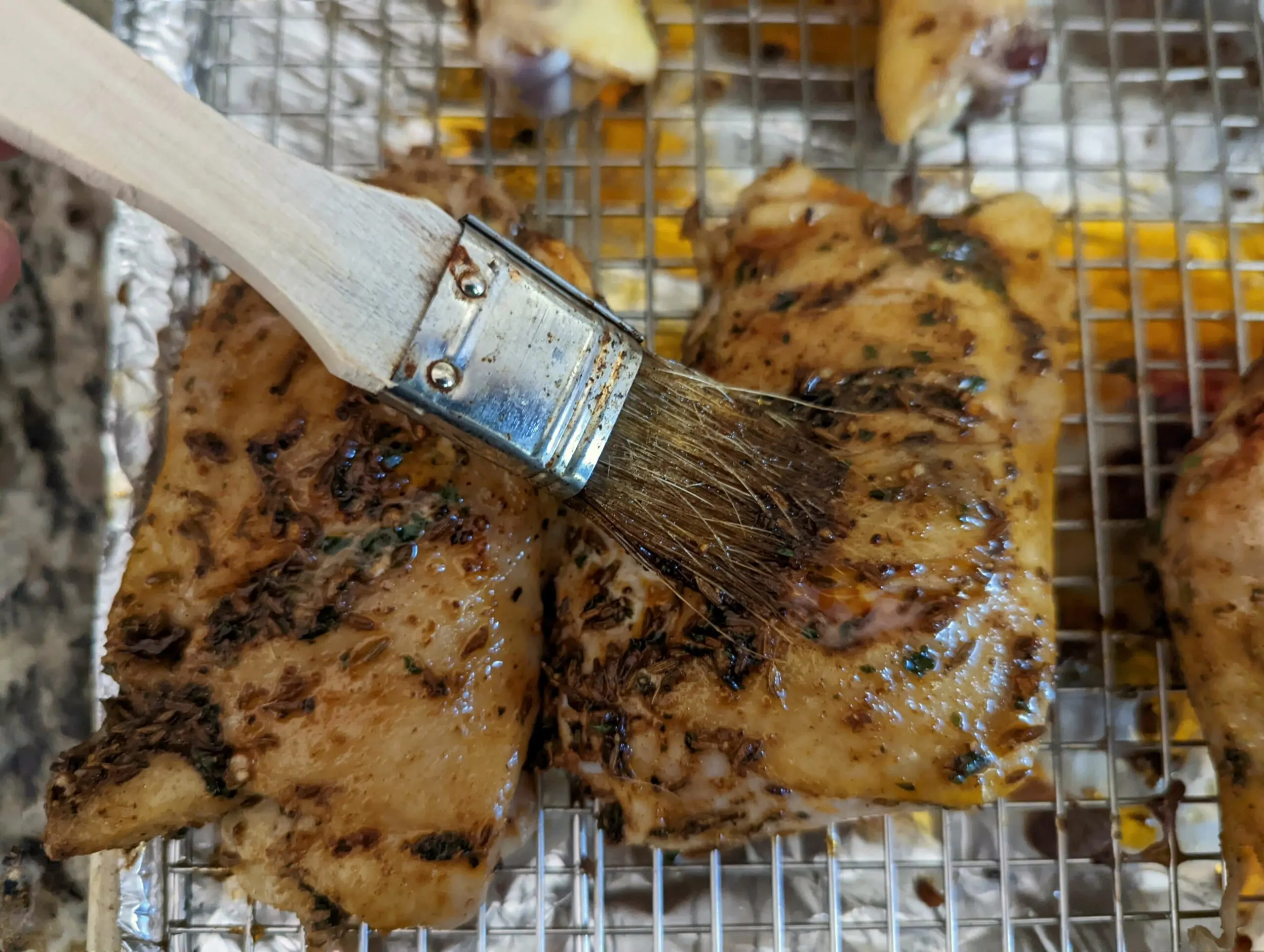 Brush more of the butter and spices onto the chicken. 