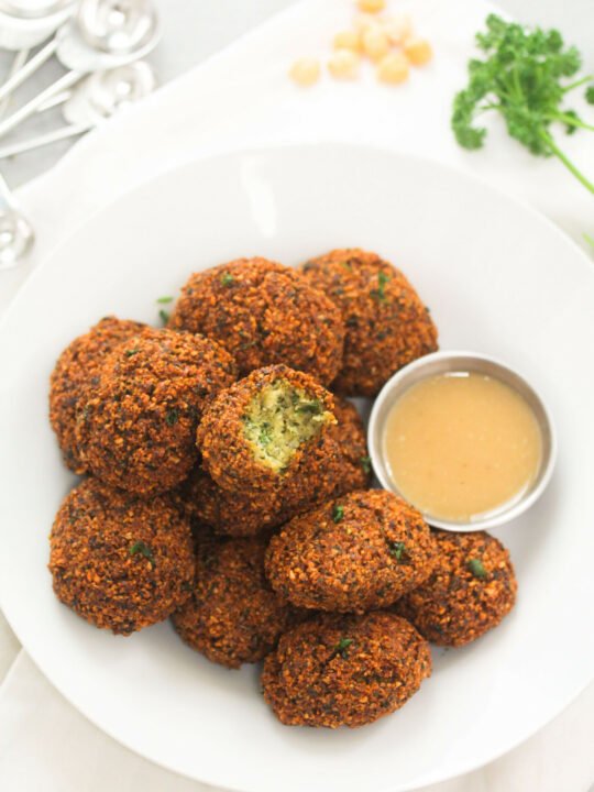 Falafels on a plate with homemade tahini.