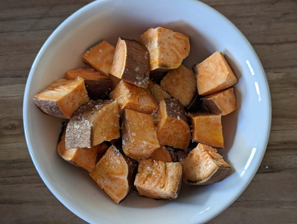 Cut the sweet potatoes into 1-inch cubes and season with kosher salt.