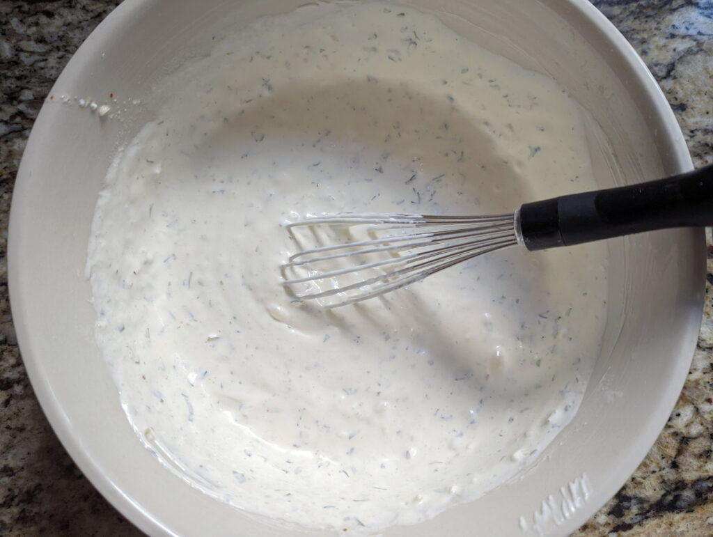 The ingredients for ranch dressing whisked in a small bowl. 