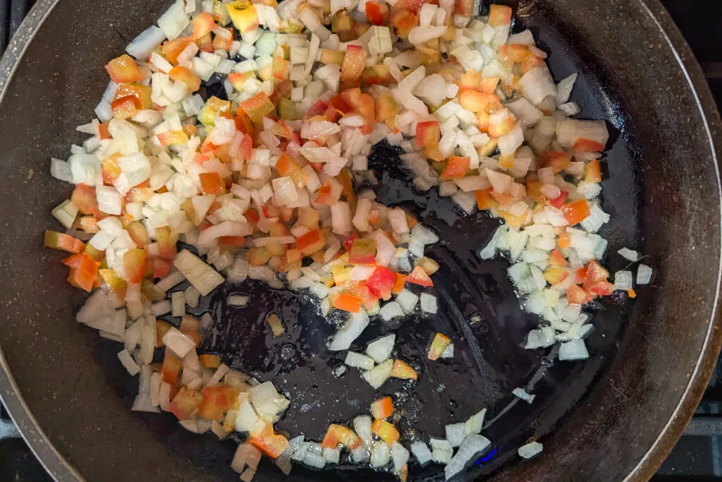 Veggies cooking in a pan.