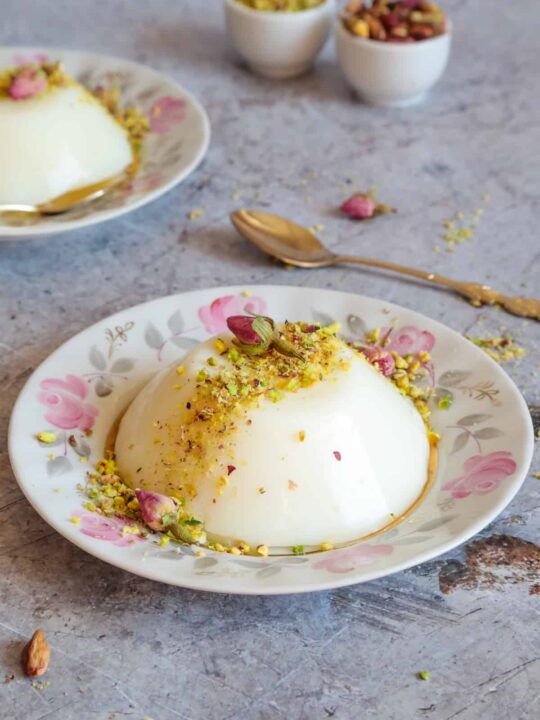 Muhalabieh is a milk pudding that's infused with rosewater and topped with crushed pistachios.