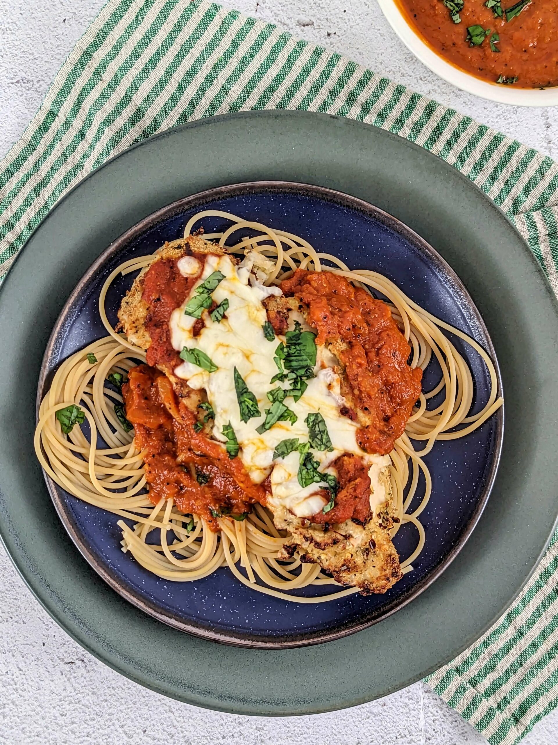 Air fryer chicken parmesan served over spaghetti noodles.