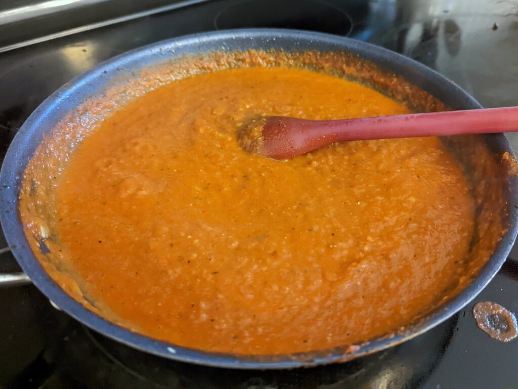 The spicy marinara pureed in a skillet.