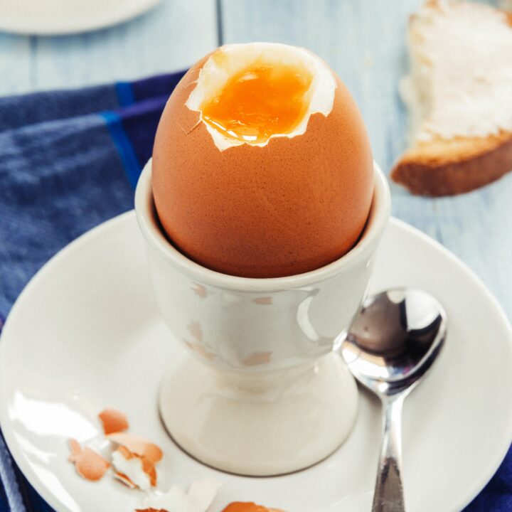 A perfectly cooked soft boiled egg cracked open.
