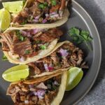 Garnish our Instant Pot Carnitas with onion and cilantro.