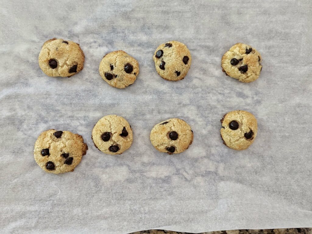 Keto chocolate chip cookies on a wire rack.