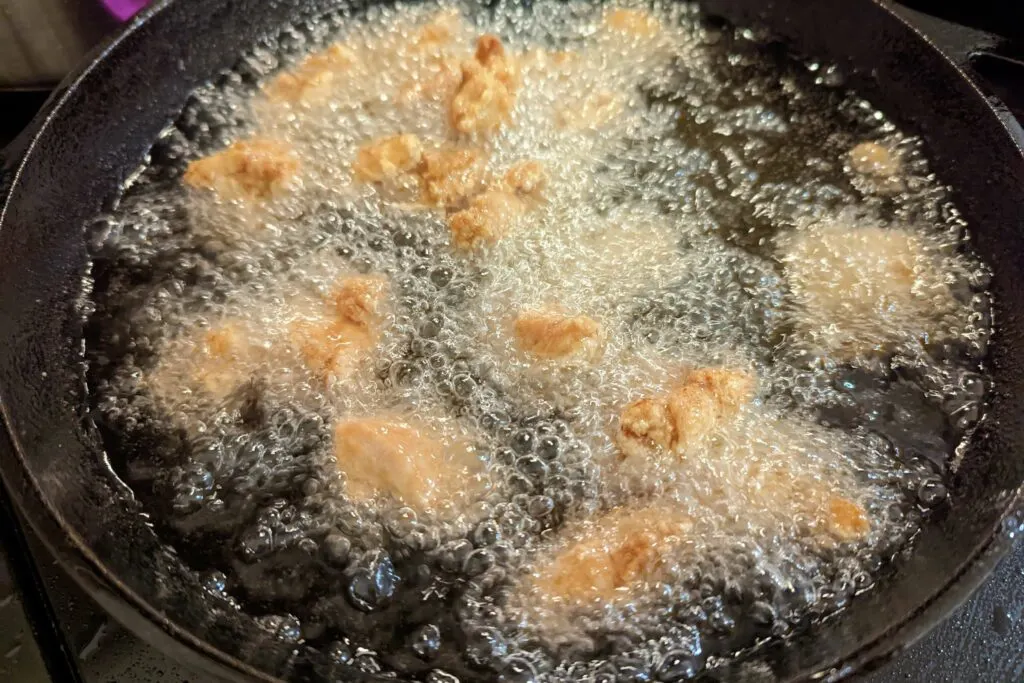 Chicken frying in a wok.