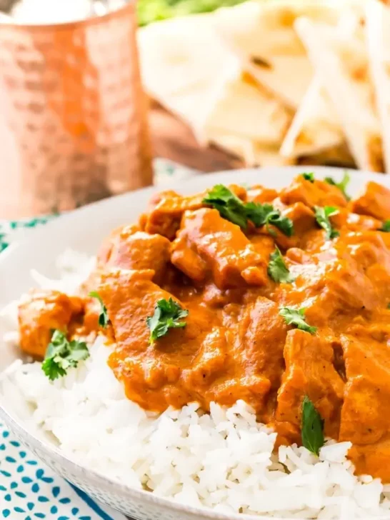 Chicken tikka masala served over rice and garnished with cilantro. 