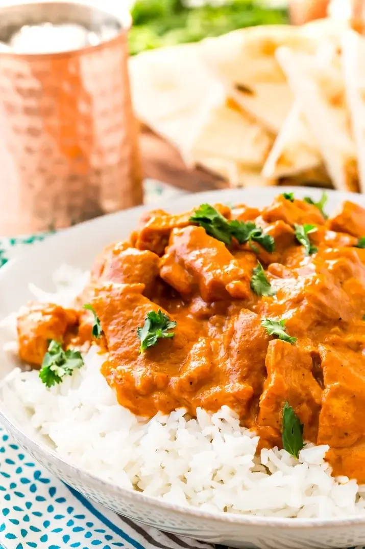 Chicken tikka masala served over rice and garnished with cilantro. 