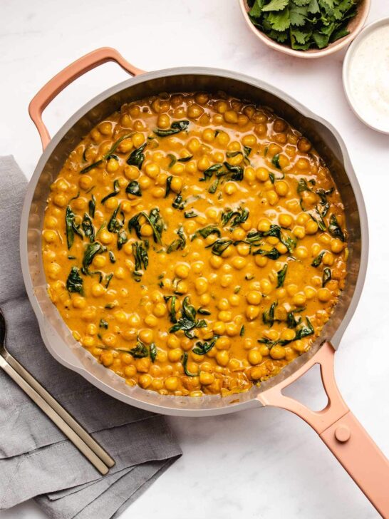 Spinach and chickpea curry in a saute pan. 